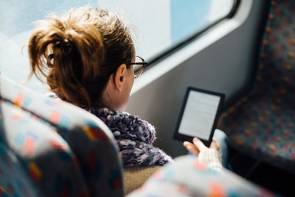 Woman reading ebook on train bus