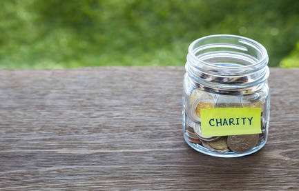 jar of coins with charity sticker